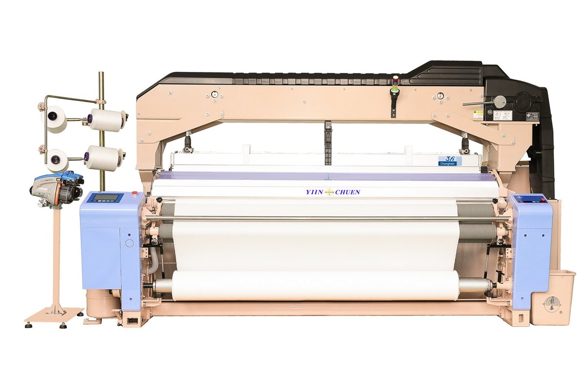 A Yiin Chuen water jet loom, full length, with creel stand, control panel and cloth beam